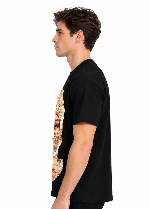 Model wearing the Imaan Vouge Adorned T-Shirt in black, side view showing the relaxed dropped-shoulder fit