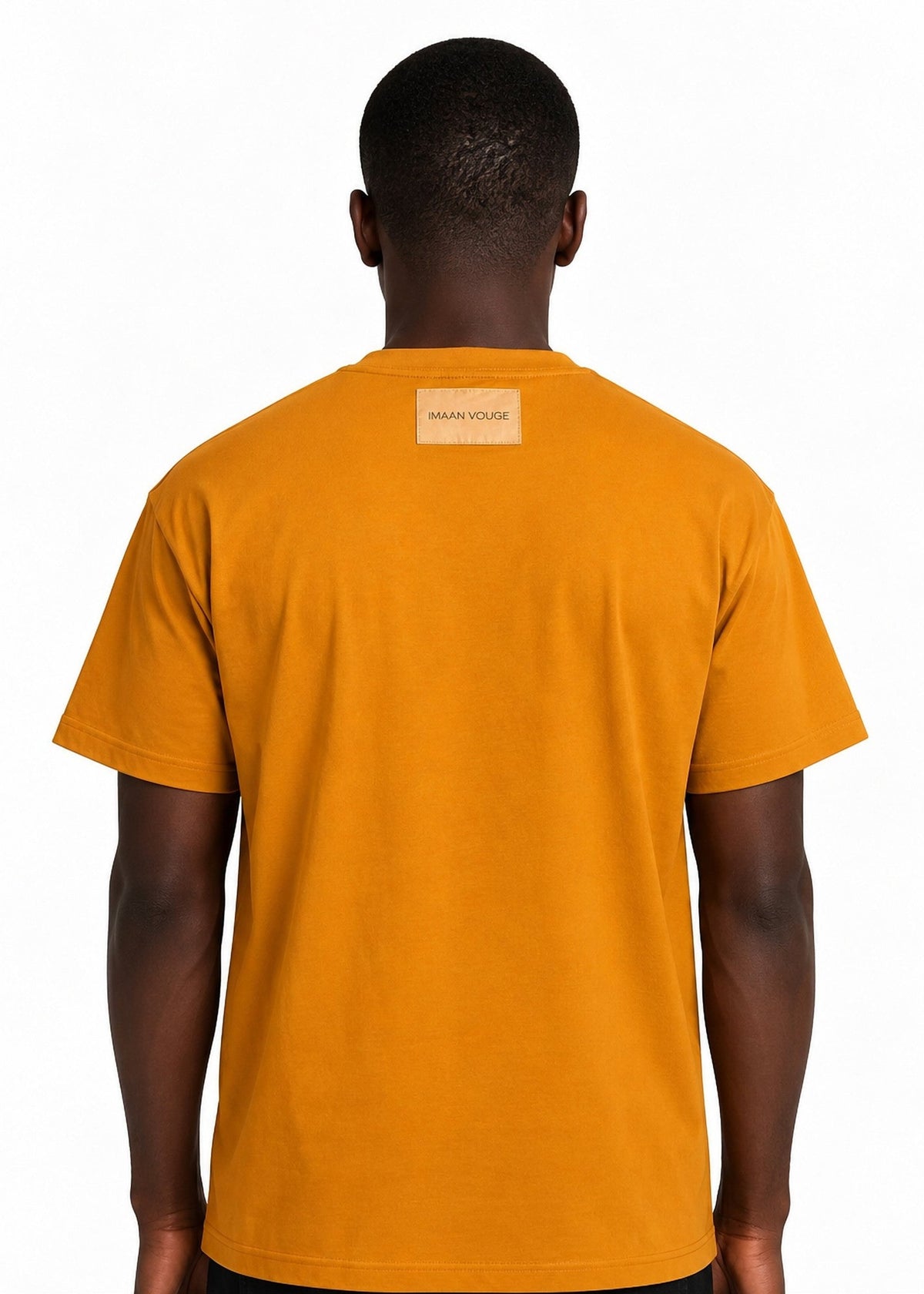Model wearing the Imaan Vouge Adorned T-Shirt in coffee brown, back view showing the signature logo patch