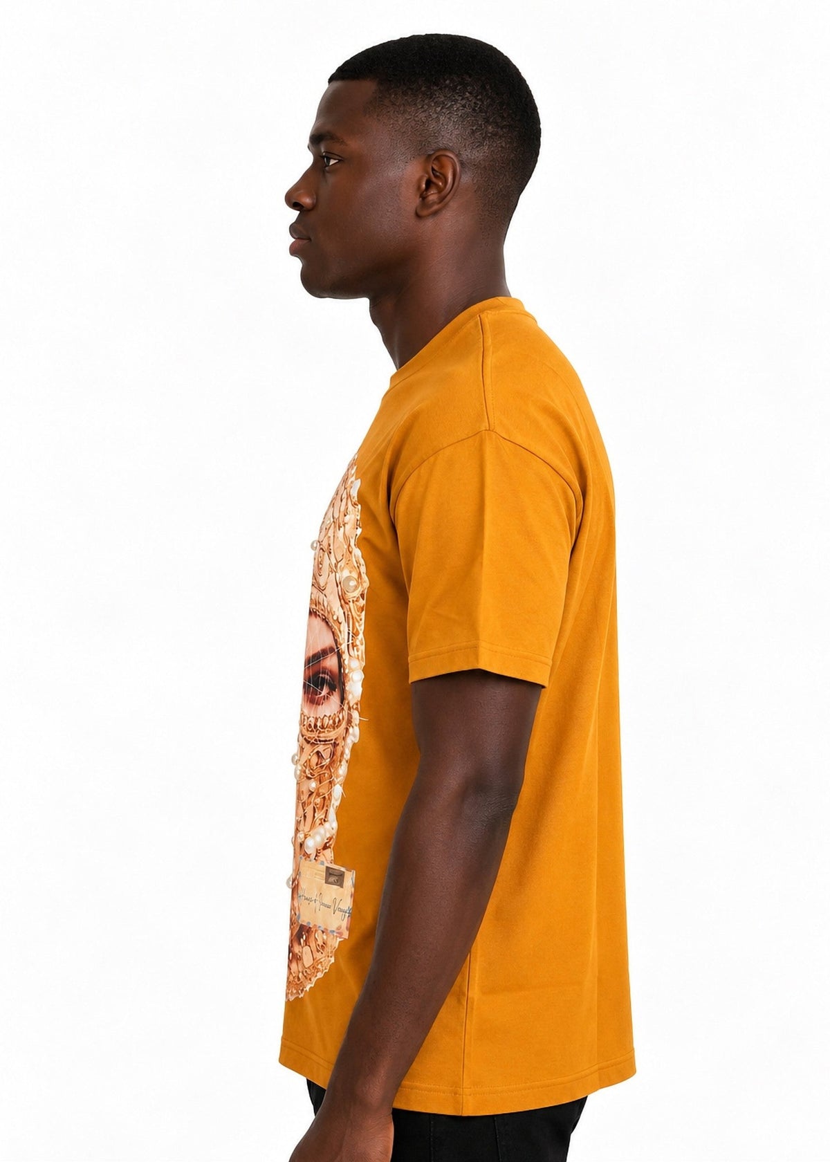 Model wearing the Imaan Vouge Adorned T-Shirt in coffee brown, side view showing the relaxed dropped-shoulder fit