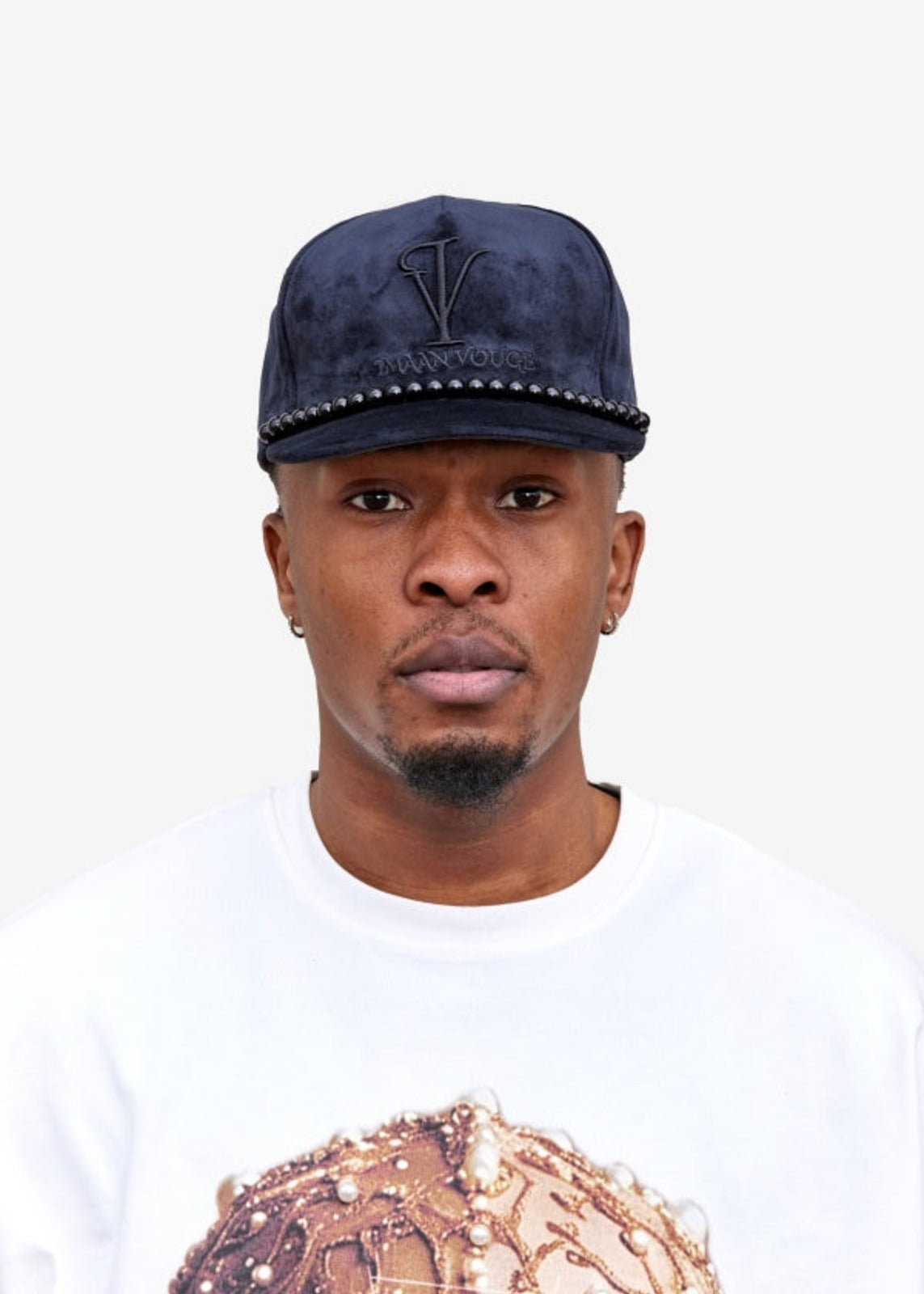 Model wearing the Imaan Vouge 5-Panel Noble Hat in black velvet with beaded trim